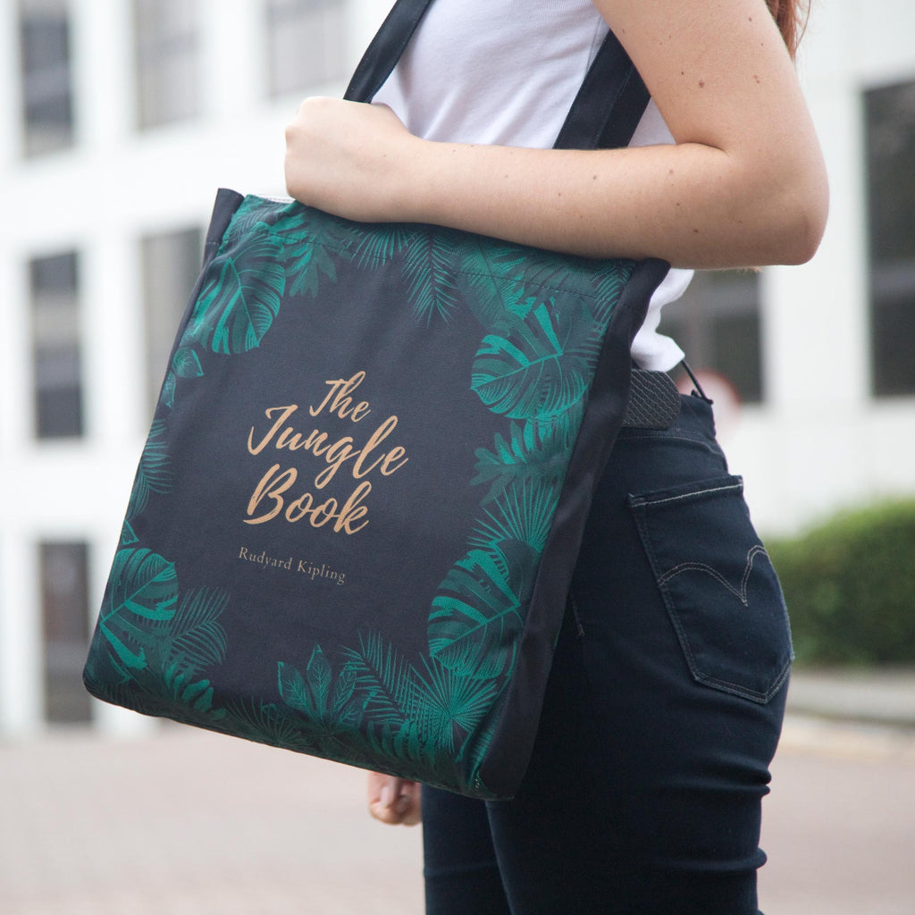 The Jungle Book Green Tote Bag by Rudyard Kipling featuring Jungle Leaves design, by Well Read Co. - Model with bag