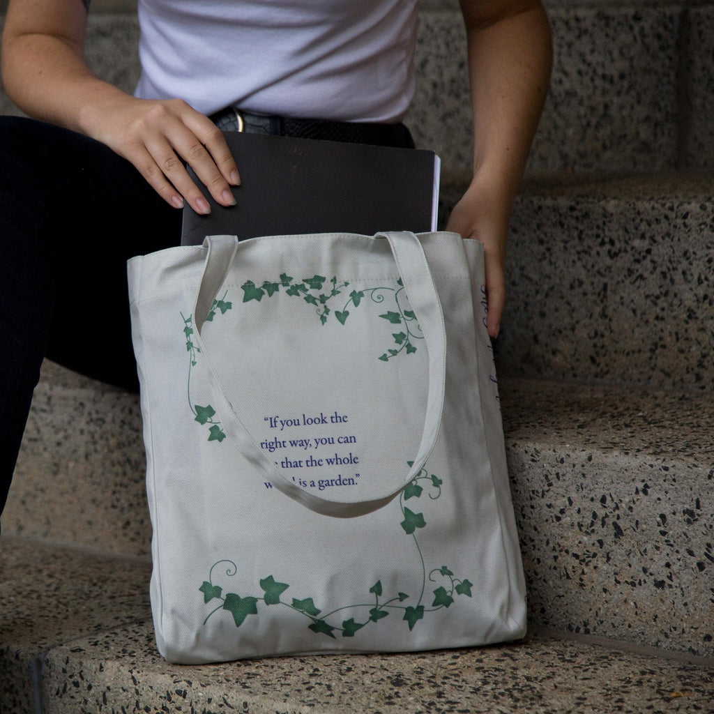 The Secret Garden Grey Tote Bag by F.H. Burnett featuring Gate and Ivy design, by Well Read Co.  - Model Sitting with Bag