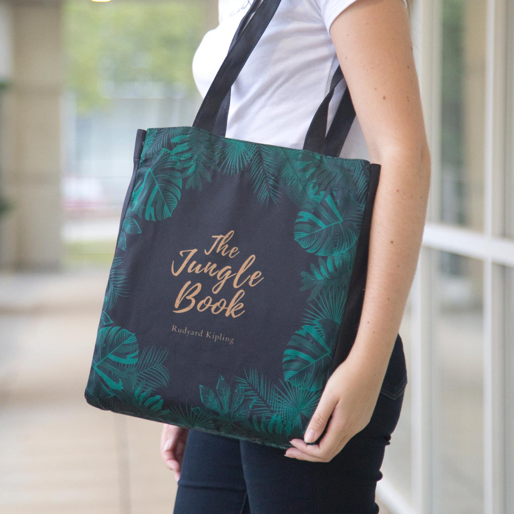 The Jungle Book Green Tote Bag by Rudyard Kipling featuring Jungle Leaves design, by Well Read Co. - Model Standing