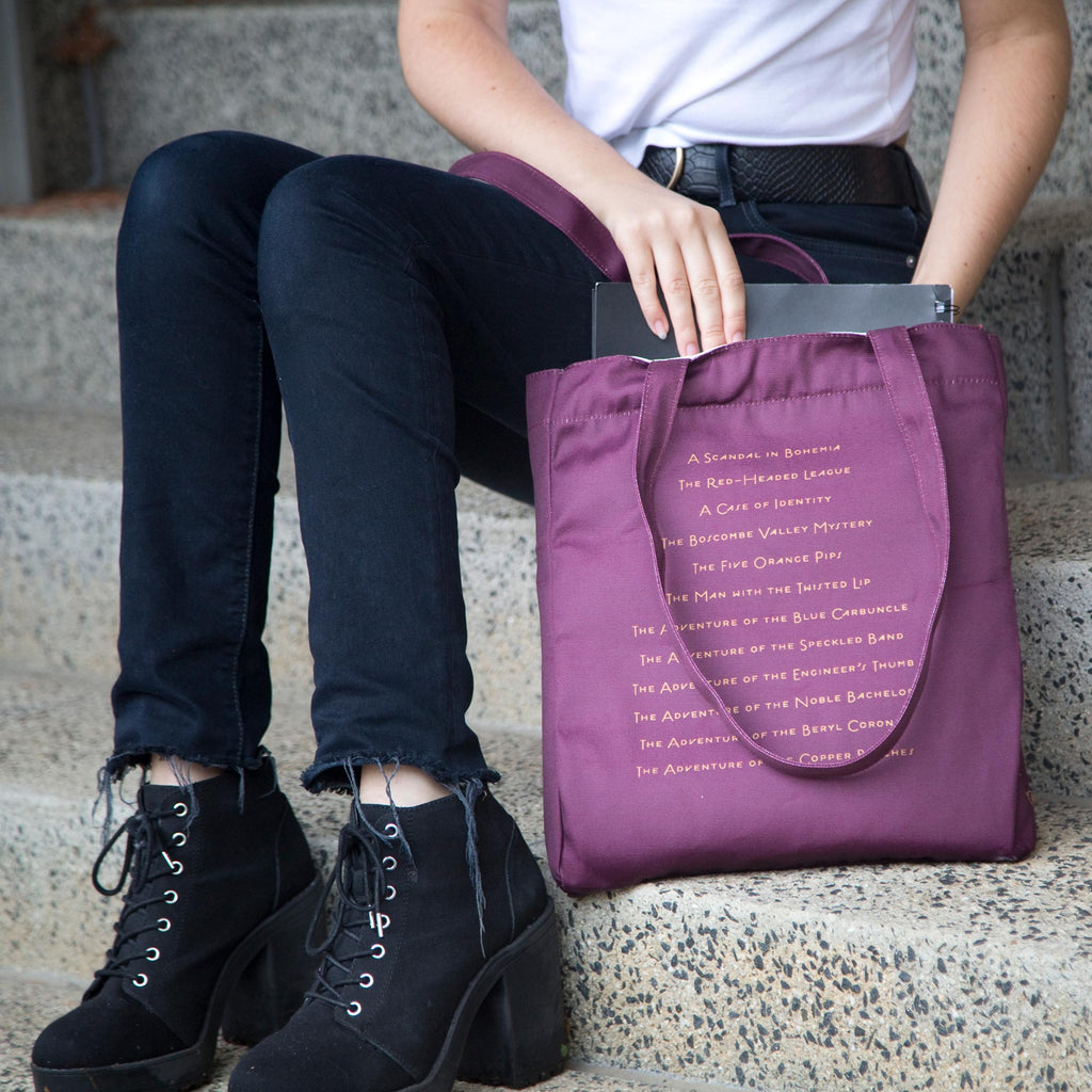 Sherlock Holmes Burgundy Tote Bag by Arthur Conan Doyle featuring Sherlock Holmes Silhouette design, by Well Read Co.  - Model Sitting with Bag