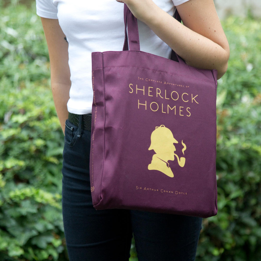 Sherlock Holmes Burgundy Tote Bag by Arthur Conan Doyle featuring Sherlock Holmes Silhouette design, by Well Read Co.  - Model Standing
