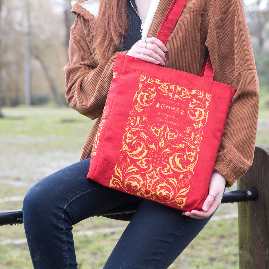 Emma Red Tote Bag by Jane Austen featuring Gold Leaf design, by Well Read Co. - model sitting