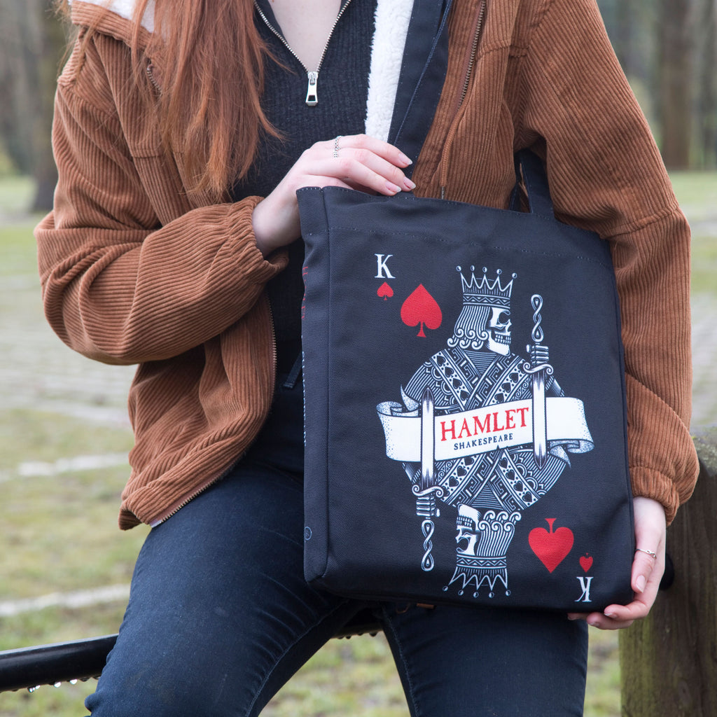 Hamlet Black Tote Bag by William Shakespeare featuring Playing Card and Skull design, by Well Read Co. - Model Sitting